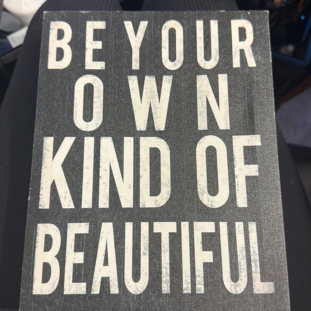 A sign that says be your own kind of beautiful